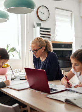 Homeschooling – Mother Helping To Her Daughters To Finish School Homework During Coronavirus Quarantine