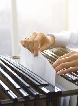 Office clerk searching files in the filing cabinet