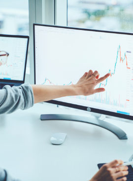 Business woman study financial market to calculate possible risks and profits.Female economist accounting money with statistics graphs pointing on screen of computer at desktop. Quotations on exchange