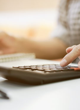 close up grandmother hand press on calculator for counting about monthly expense or planning money management after retired concept