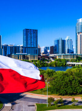 Perfect Texas flag flying in front of Austin Texas downtown skyline cityscape sunny perfect day