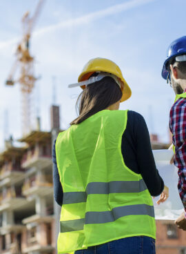 Construction worker and his manager checking the progress