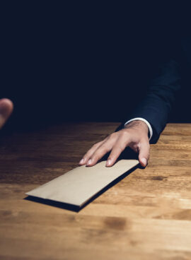 Businessman rejecting money in the envelope