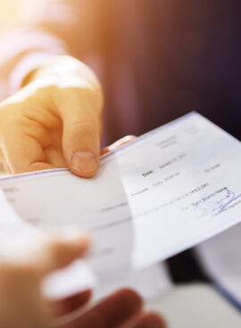 Businessperson Hands Giving Cheque