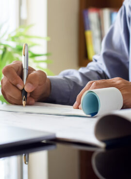 Architect man or male engineer hand writing and sign check book. Paycheck, sign check concept.