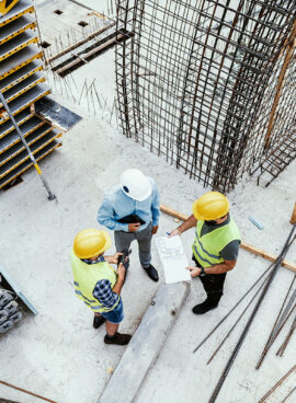 Unrecognisable Engineers on construction site, high angle view of employees in construction industry