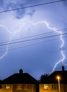 Lightning Storm in Night Sky Above Houses