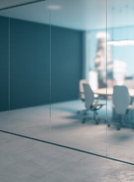 Side view on meeting room with light modern furniture and city view from glass wall behind blurred glass partition from office area with concrete floor. 3D rendering